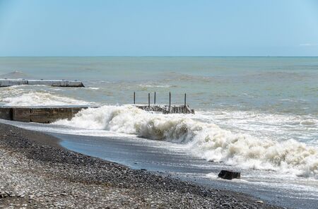 Sea wave with spray during storm at Black sea in Sochi, Russia. Muddy sea waves with foam and spray.の写真素材