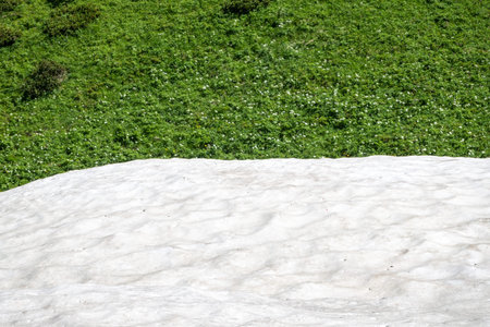 White snow high in the mountains in summer. Summer in the mountains.の写真素材