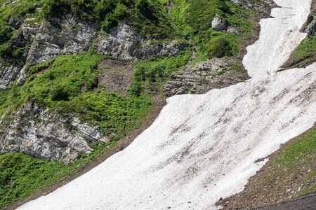 White snow high in the mountains in summer. Summer in the mountains.の写真素材