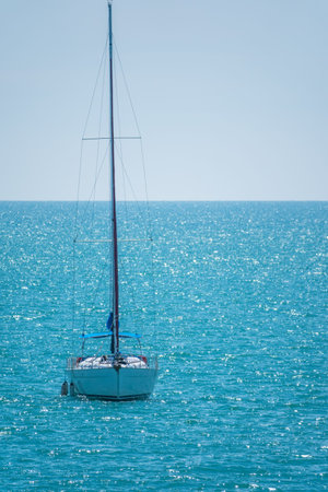 Sailing yacht in the blue calm sea. A yacht in peaceful waters.