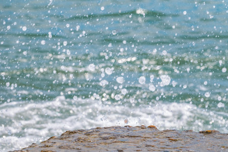Splashes and drops of water on a blue sea background. Abstract Splash of Water on a Blue Background