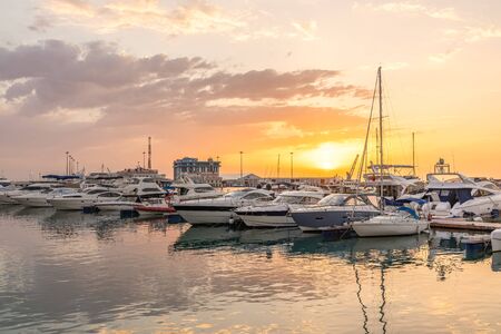 Beautiful sunset in the sea harbor with moored yachts. Sochi, Russia.の写真素材