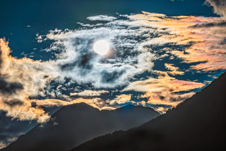 Silhouette of mountain range at orange cloudy sunset Beautiful sunset in mountains