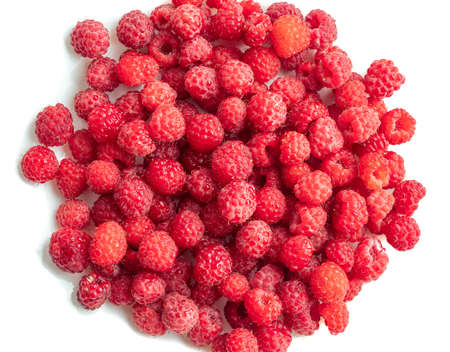 Raspberry scatter isolated on white background. Background from fresh bright red raspberries.の写真素材
