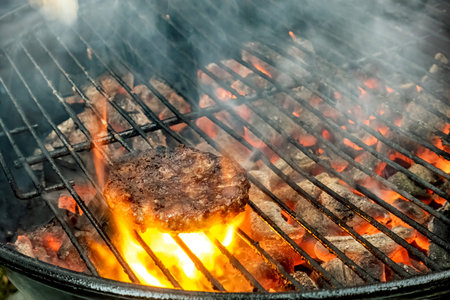 Juicy meat steaks cooked over charcoal on a wire rack. Meat cooked on a fire in the open air....