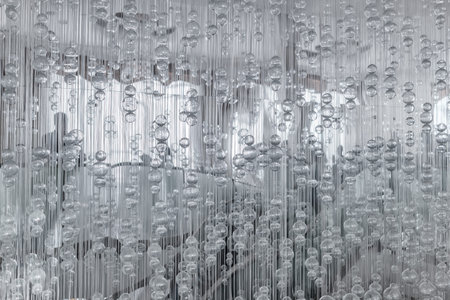 Abstract black and white glass balls hang on threads. Beautiful crystal balls hanging on fine...