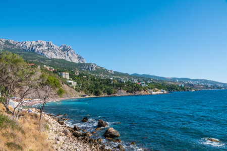 Sea view with rocky beaches and cliffs. Tourism in the Crimea. Summer photo of a sea landscape. Crimean Mountains and sea near town of Alupka, Crimea.の写真素材