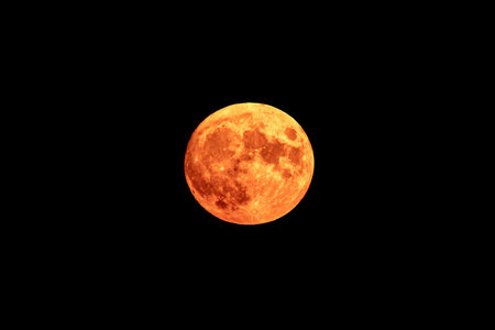 Bright orange and red fool moon over the sea. Red full moon in red color also called bloodmoonの写真素材