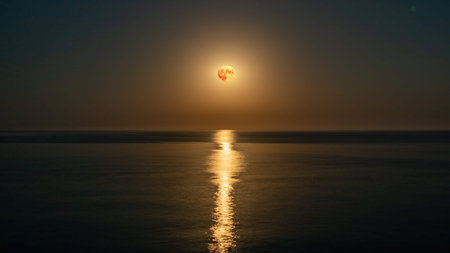 Super full blood moon and moon light over the sea. Full red moon with reflection in water with...