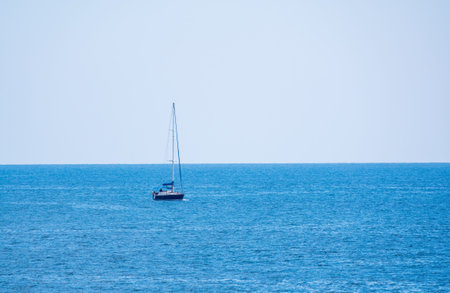 Sailing yacht in the blue calm sea. A yacht in peaceful waters.