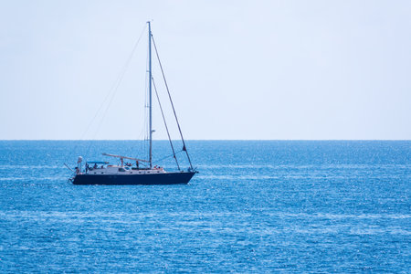 Sailing yacht in the blue calm sea. A yacht in peaceful waters.の写真素材