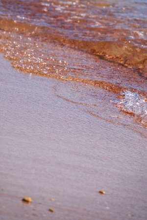 Soft wave of the sea on the sandy beach. Sea wave and gold sand.の写真素材