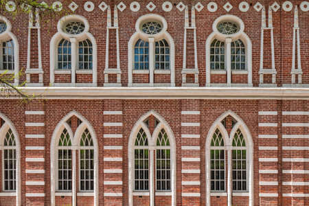 Brick wall of an old 18th century building with large windows. Large windows in an old red brick building. Grand Palace in Tsaritsyno Park, Moscow, Russiaの写真素材