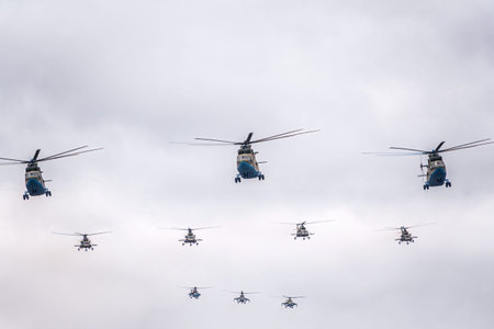 Moscow, Russia - May, 09, 2021: A group of Mi-26 transport helicopters, Mi-8 helicopters and three Mi-35 attack helicopters flies over Red Square during the parade celebrating Victory Day in Moscow.のeditorial素材