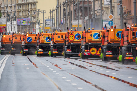 Moscow, Russia - May 5, 2021: A column of sweeper cars after the May 9 parade in Moscow. The street sweeper is moving on the road. City improvement by municipal services.のeditorial素材