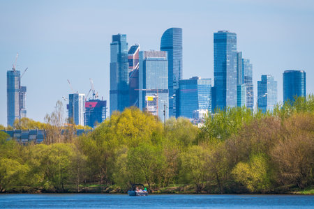 River and green trees on background modern skyscrapers in the Moscow city.の写真素材