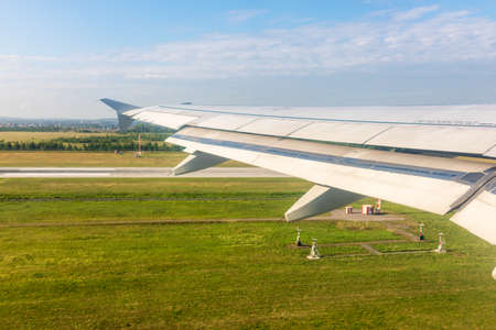 View from the airplane window during takeoff at Koltsovo airport on a clear summer morning. Yekaterinburg, Russiaの写真素材