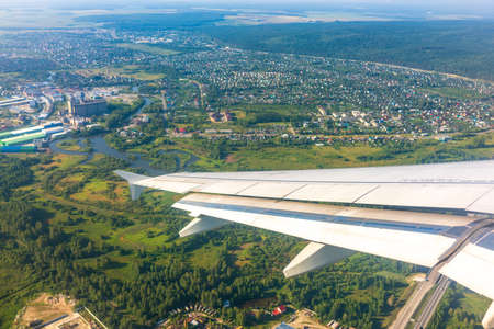 View from the airplane window during takeoff at Koltsovo airport on a clear summer morning. Yekaterinburg, Russiaの写真素材