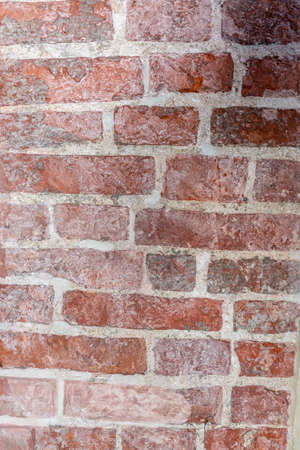 Fragment of an ancient medieval brick wall. Vintage bricks. Old wall.の写真素材