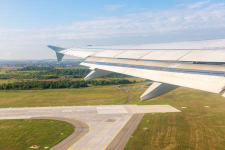 View from the airplane window during takeoff at Koltsovo airport on a clear summer morning. Yekaterinburg, Russiaの写真素材