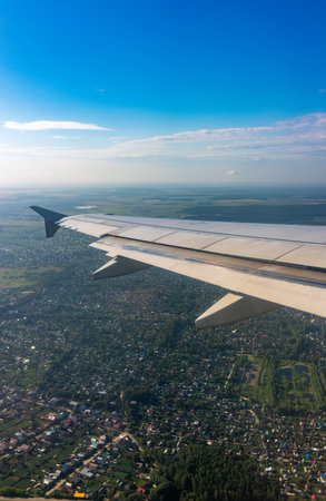 View from the airplane window during takeoff at Koltsovo airport on a clear summer morning. Yekaterinburg, Russiaの写真素材
