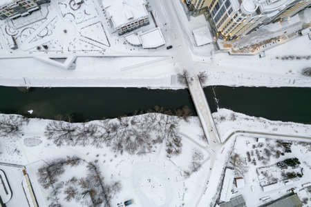 Small park with bare trees covered with snow. Aerial view of residential area in winter. Aerial view to winter park in Yekaterinburgの写真素材