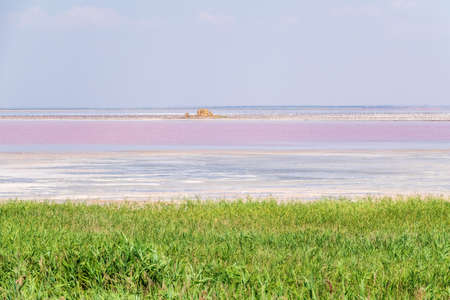 A beautiful salt lake with pink water. Beautiful view of pink lake on summer dayの写真素材