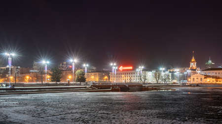 Early Spring night on the banks of the pond in the city center. Illuminated buildings. Spring has come. The ice in the river began to melt. Yekaterinburg, Russiaの写真素材
