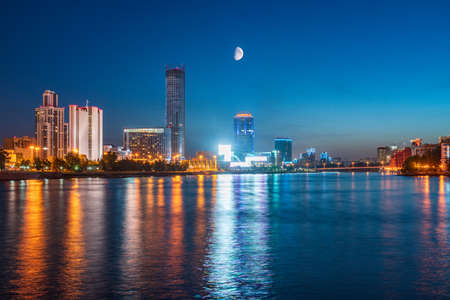Night with big moon on a pond in the center of the city. Yekaterinburg city and pond at night. Yekaterinburg, Russiaの写真素材