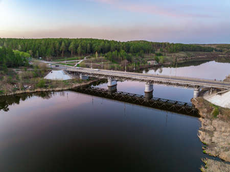 Beautiful view of the bridge across the Iset river in the city of Kamensk-Uralsky at sunset in spring. Kamensk-Uralskiy, Sverdlovsk region, Ural mountains, Russia. Aerial viewの写真素材