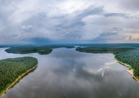 Big lake with green shores in bright sun light, aerial landscape. Recreational concept. sky reflection. Ecology in Europe. Aerial viewの写真素材