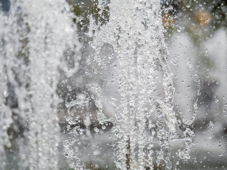Water splashes from fountain on dark background. Natural texture of only water of fountain. High...