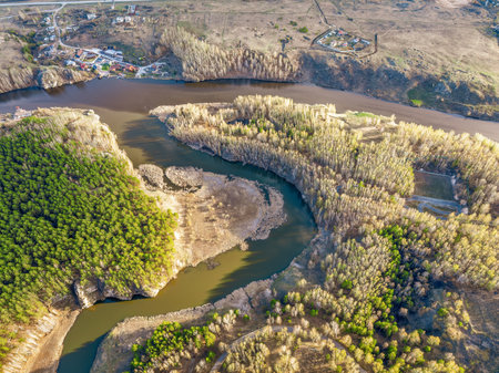 Confluence of the Iset and Kamenka rivers in the city Kamensk-Uralskiy. Iset and Kamenka rivers, Kamensk-Uralskiy, Sverdlovsk region, Ural mountains, Russia. aerial view. Spring sunset landscapeの写真素材