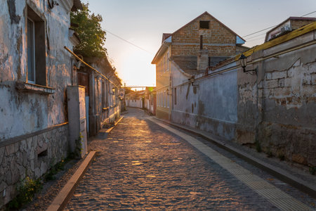 Street of the Old Town of Evpatoria at sunset. Narrow streets with stone pavements of the old resort town. Walking tour routeの写真素材
