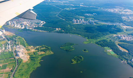 View from the airplane window during takeoff at Koltsovo airport on a clear summer morning....