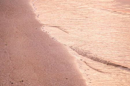 Soft wave of the sea on the sandy beach. Sea wave and gold sand.の写真素材