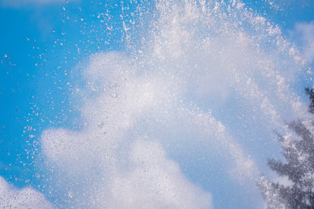 Splashes of water against the blue sky background. Fountain, a jet of water against the blue sky.の写真素材