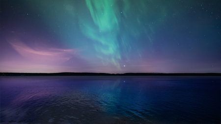 Magical landscape with a lake and northern lights in the starry sky. Northern Lights shot in the summer time by the lakeの写真素材