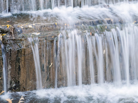 A small flat cascade in a calm river. Water background