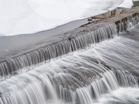 A small flat cascade in a calm river. Water backgroundの写真素材