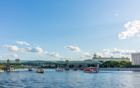 View of the Moscow river embakment, Pushkinsky bridge and cruise ships at sunset. Wide Moskva River, Pushkinsky bridge, Groky Park, Frunzenskaya embankment,の写真素材