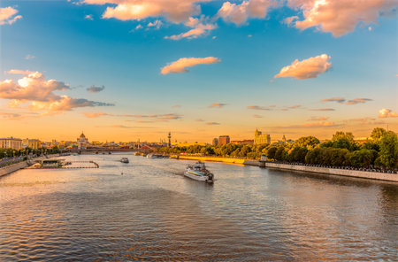 Cruise ship sails on the Moscow river in Moscow city center, popular place for walking. Panoramic view of Moscow river with cruise boatの写真素材