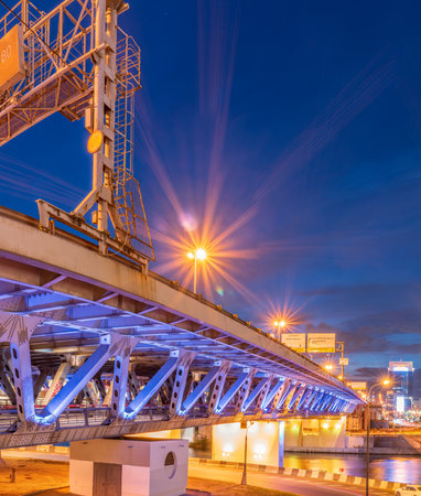 The scyscrapers of the Moscow City at night and the Dorogomilovsky bridge with illumination. Moscow, Russia - urban background. Translation of text - street names: Krasnopresnenskaya, center, etc.の写真素材