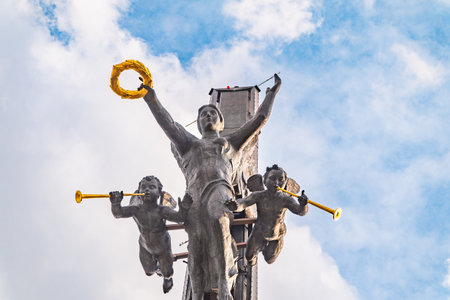 Moscow, Russia - July 31, 2022: Bronze statue of the goddess of Victory Nike and figures of angels on top of Victory Obelisk at Poklonnaya Hill,Victory Park against blue sky. Author Zurab Tsereteliのeditorial素材