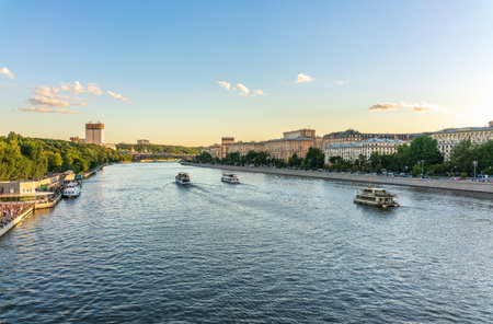 Cruise ship sails on the Moscow river in Moscow city center, popular place for walking. Panoramic view of Moscow river with cruise boatの写真素材