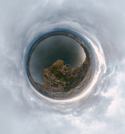Autumn forest on lake shore at sunset and city on horizon, aerial view. Lake Shartash and Yekaterinburg, Russia. Little planet sphere modeの写真素材