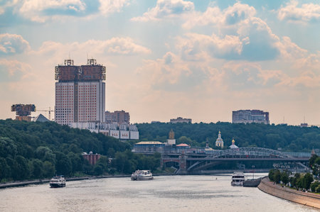 Cruise ship sails on the Moscow river in Moscow city center, popular place for walking. Panoramic view of Moscow river with cruise boatの写真素材