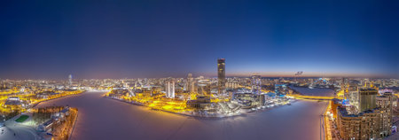 Yekaterinburg aerial panoramic view in Winter at sunset. Yekaterinburg city and pond in winter....