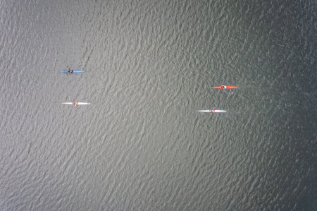 Kayaking top view. Group of kayaks rowing. Kayaks float on the river, view from above. Aerial view...