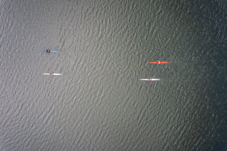 Kayaking top view. Group of kayaks rowing. Kayaks float on the river, view from above. Aerial view from drone.の写真素材
